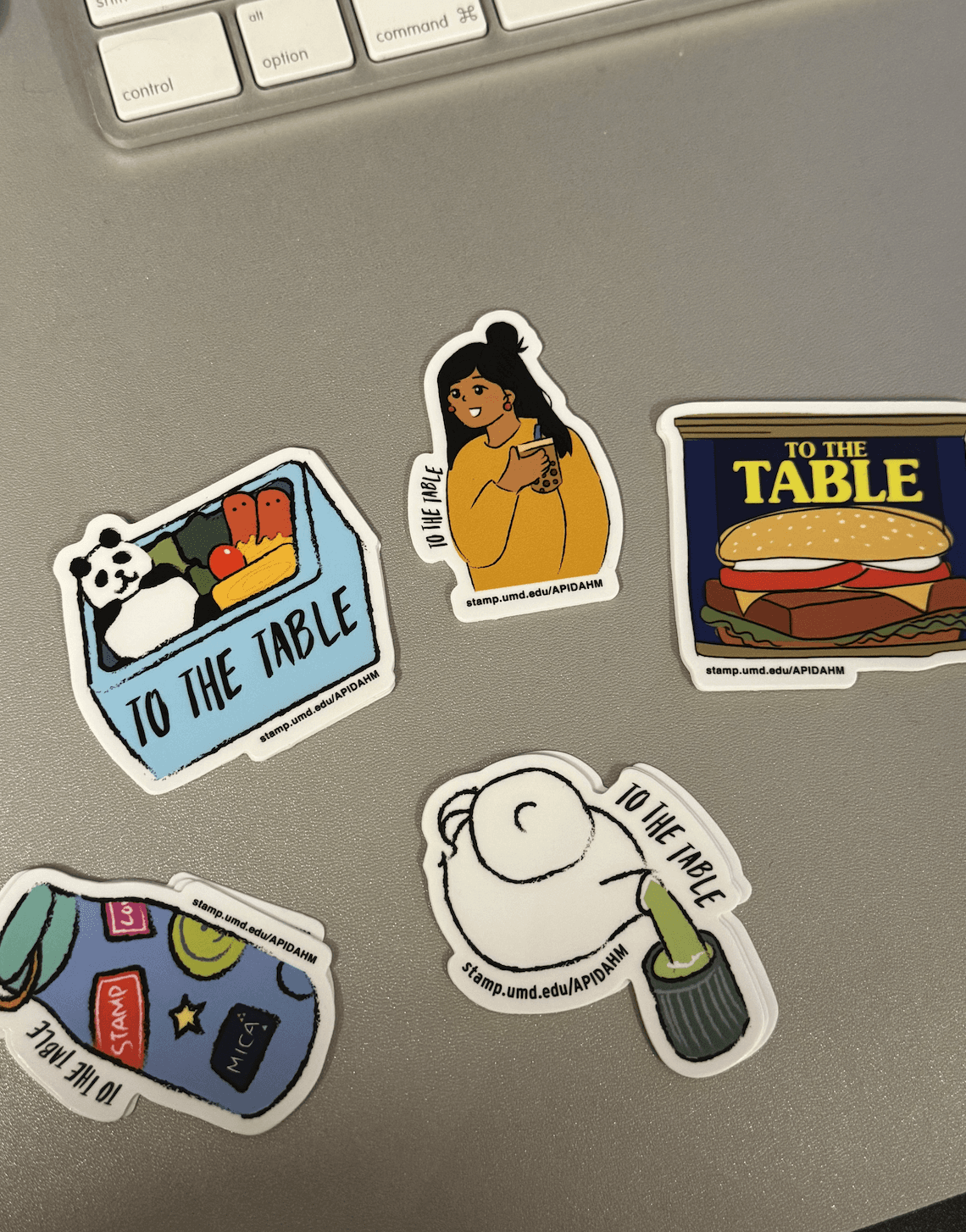 To the Table stickers on laptop